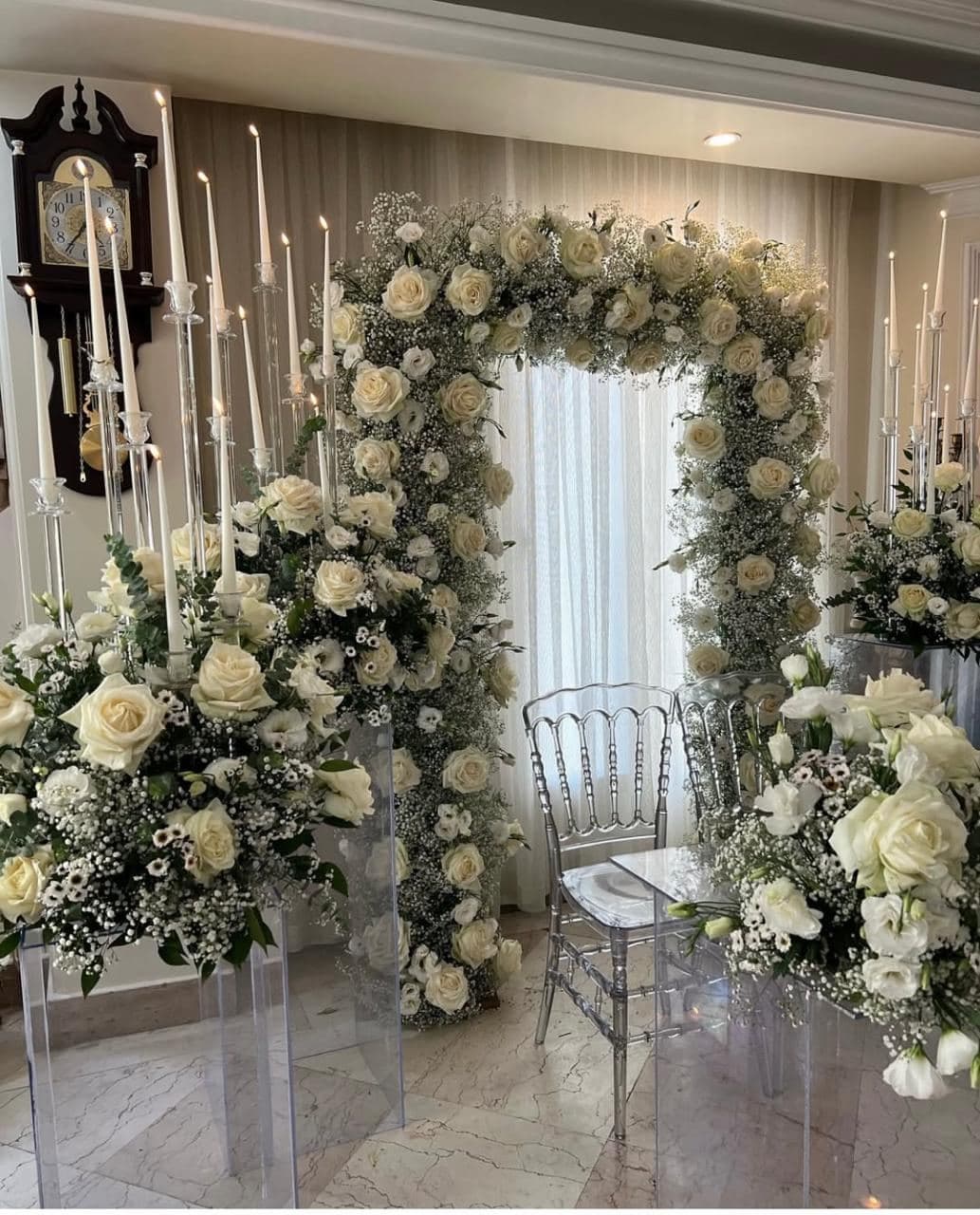Lush white floral arch with candelabras
